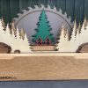 Picture of wooden trophy with trees, a sawblade and Glennon Brothers logo.