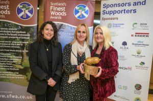 Cabinet Secretary with winners of Early Years Award, holding 'acorn' trophy